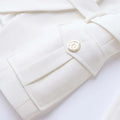 Luxury white pocket blazer with classic double-breasted design for women.