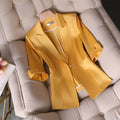 Women's slim waist yellow blazer jacket with three-quarter sleeves displayed on a chair.