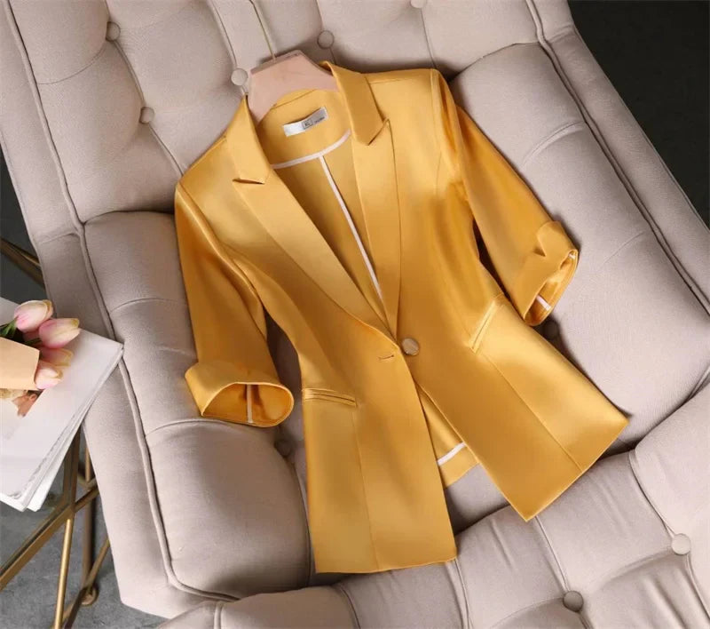 Women's slim waist yellow blazer jacket with three-quarter sleeves displayed on a chair.