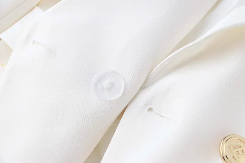 Close-up of white luxury office blazer fabric with button detail, featuring a classic style for women.