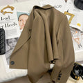 Women's loose solid color short suit jacket with notched collar and single button closure.