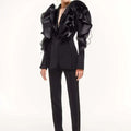 Women's slim black blazer coat with long sleeves and ruffle details, featuring a shawl collar and single button closure.