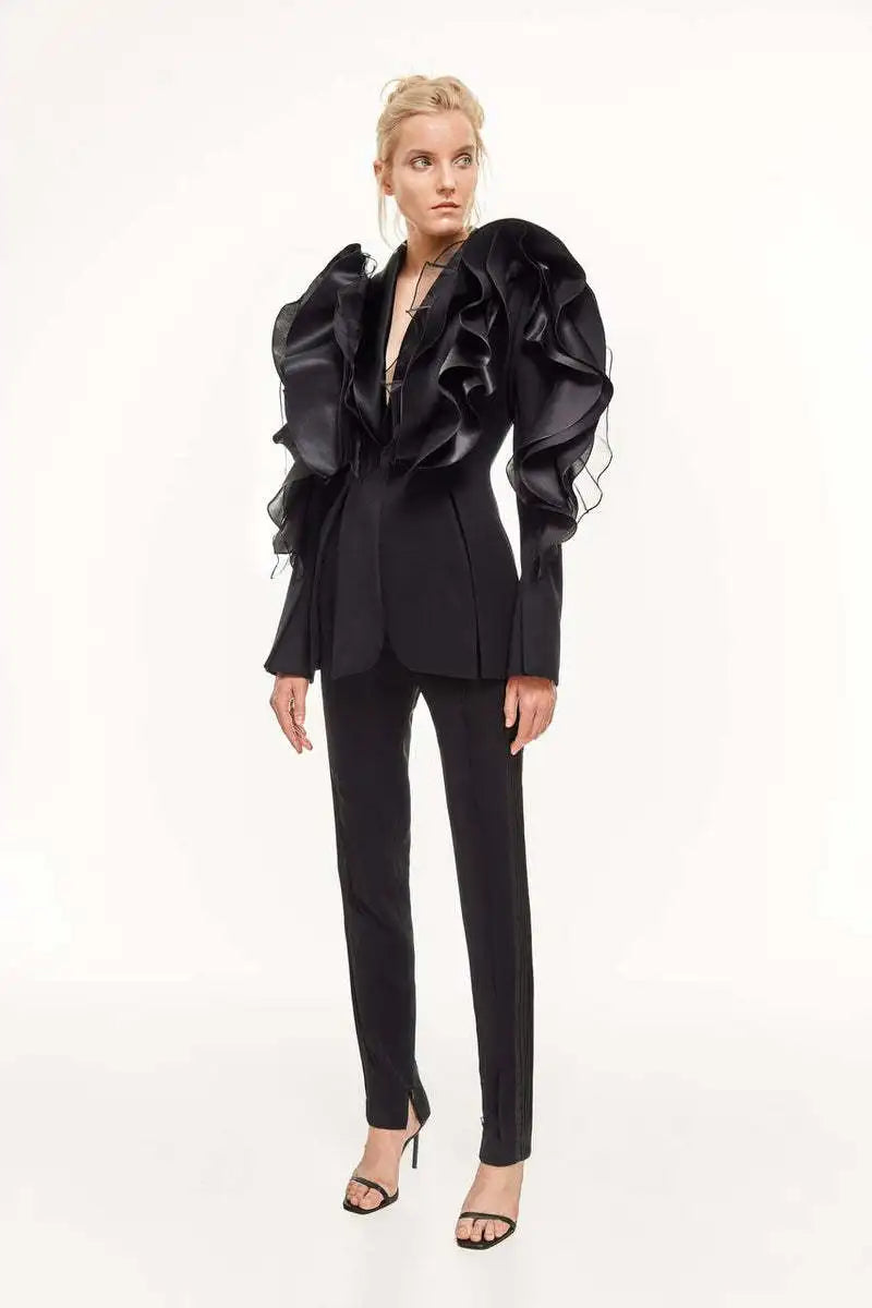 Women's slim black blazer coat with long sleeves and ruffle details, featuring a shawl collar and single button closure.