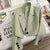 Women's loose solid color short suit jacket with notched collar and single button closure, ideal for spring and fall fashion.