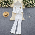 White metal buckle single breasted blazer and high waisted wide leg pants two piece suit for women on display.