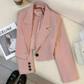 Women's loose short solid color suit jacket with notched collar and single button closure.