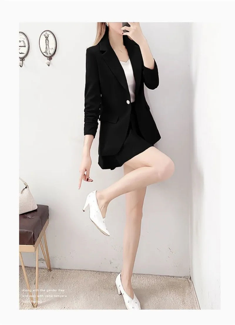 Women's chic two-piece suit with thin unlined blazer and A-line skirt.