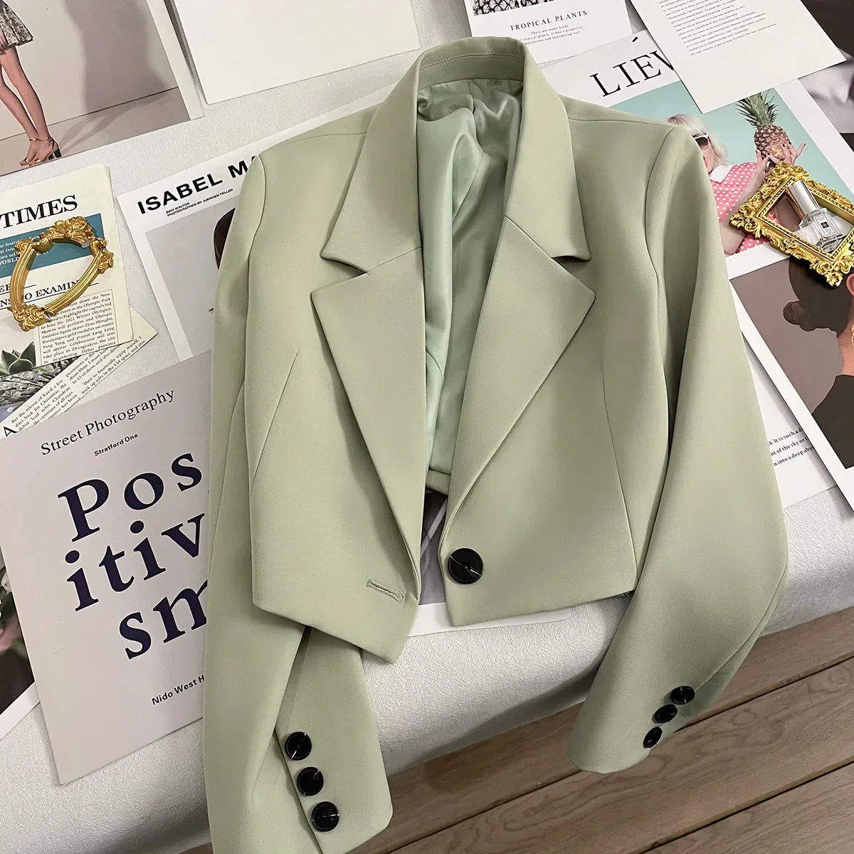 Women's loose short suit jacket, solid color with notched collar, single button closure, polyester fabric.