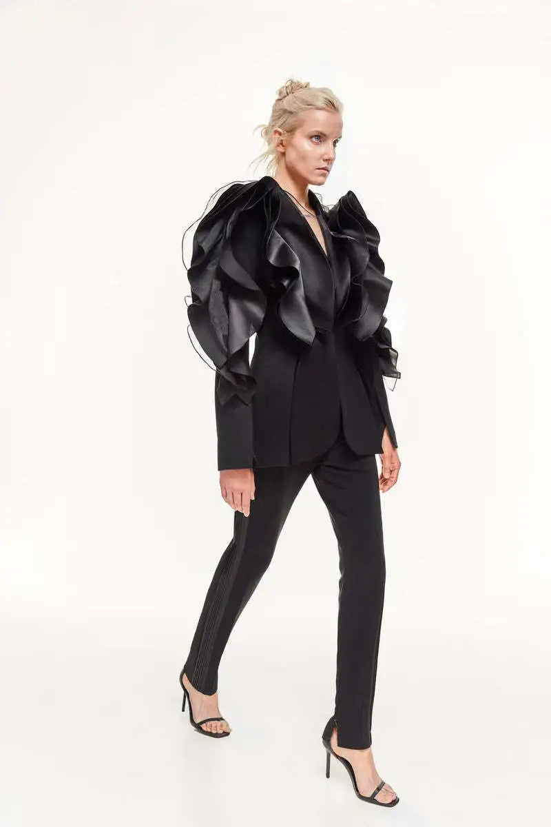 Women's slim black blazer coat with ruffles and shawl collar.