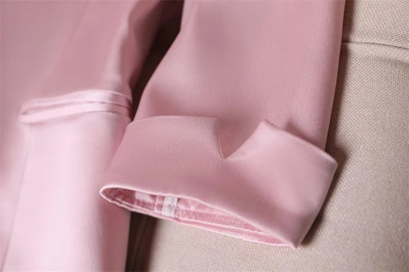 Slim waist jacket blazer with cropped sleeve detail in pink fabric.