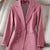 Women's long sleeve triple-breasted pink blazer with notched collar.