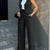 Women's casual slim notched blazer pant set in black, featuring a sleeveless blazer and high-waisted ankle-length pants.