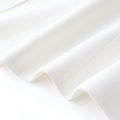 Luxury white blazer fabric with smooth texture.