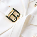 Luxury white blazer with stylish pocket details and a prominent gold buckle.