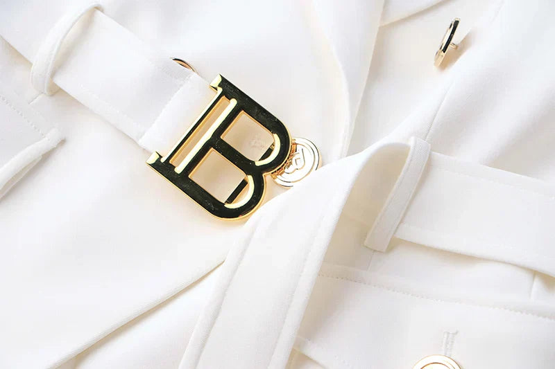 Luxury white blazer with stylish pocket details and a prominent gold buckle.