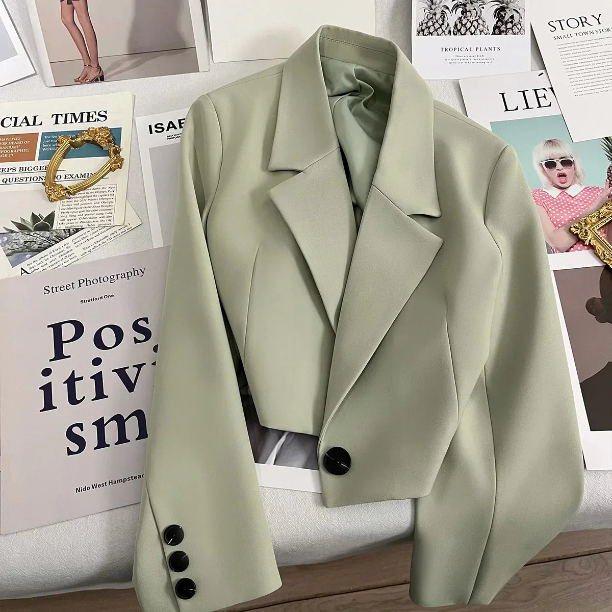 Women's solid color short suit jacket with notched collar and single button, suitable for office style in spring and fall.